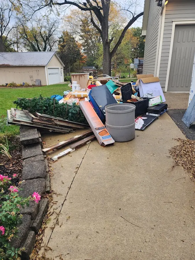 Dumpster being loaded with debris for Estate Cleanout Dumpster Rental in Mount Shasta